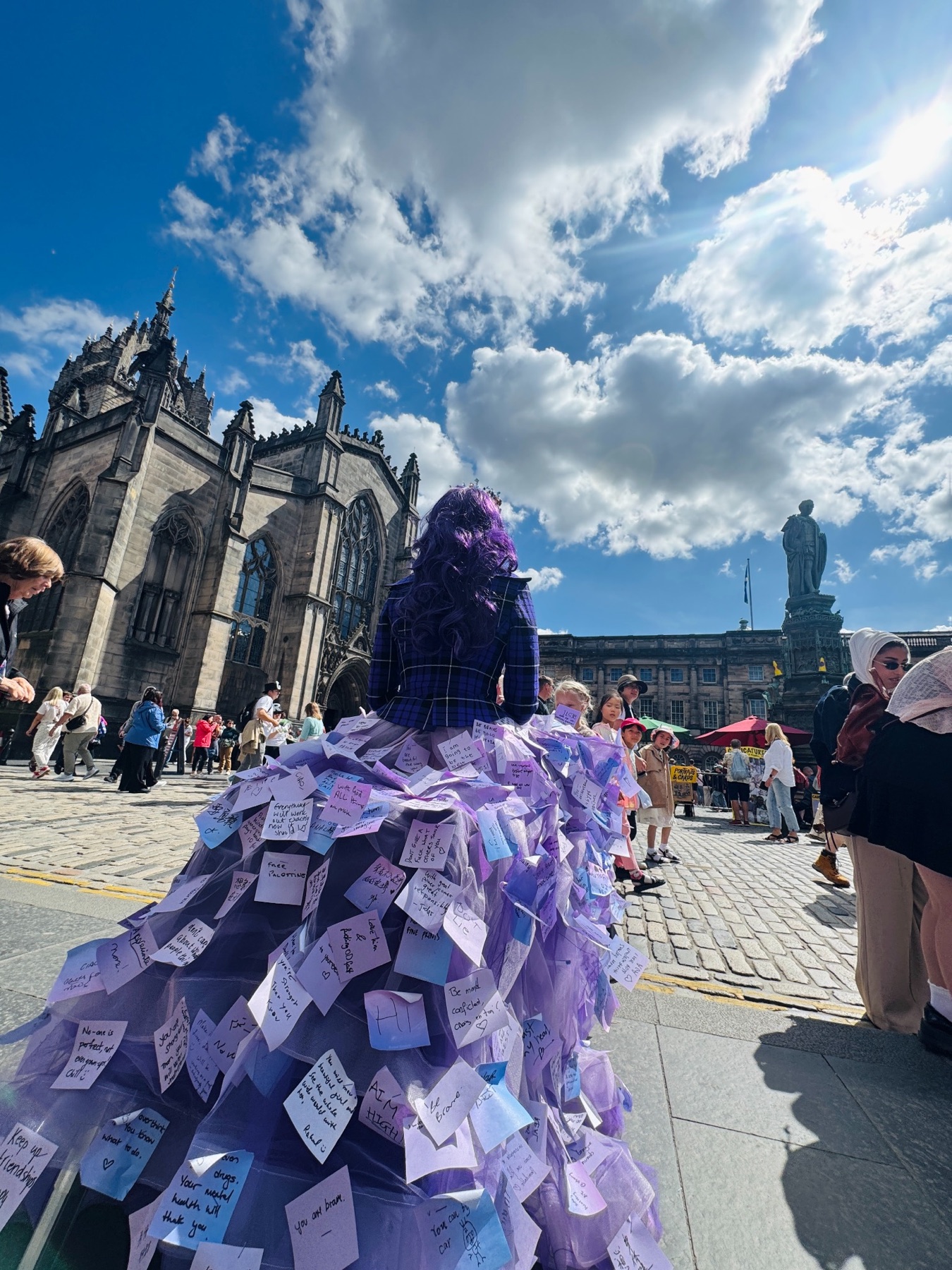 The Purple Threads skirt in a busy Edinburgh square beneath a wide blue sky